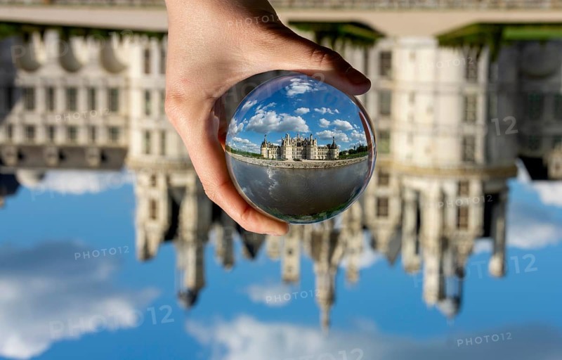 View of the Chateau de Chambord through a transparent ball. Loir-et-Cher department, Centre-Val de Loire, France, Europe