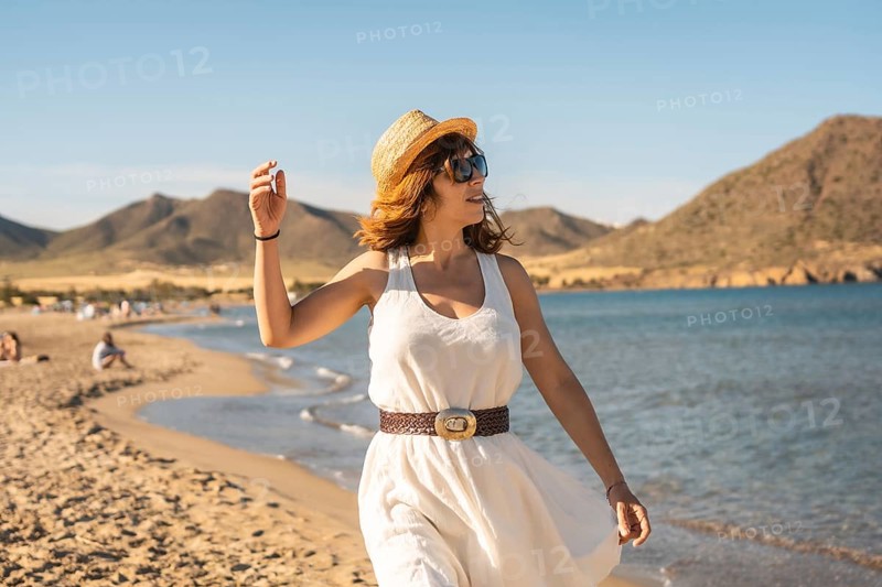 Woman enjoying alone walking along a beach in Cabo de Gata, Spain, Europe