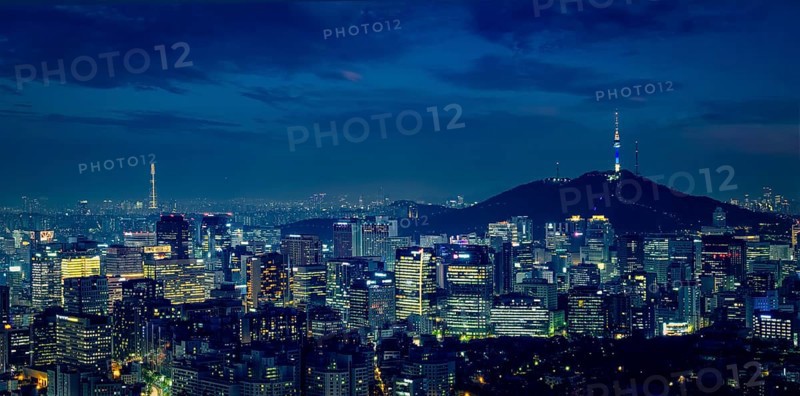 Panorama of Seoul downtown cityscape illuminated with lights and Namsan Seoul Tower in the evening view from Inwang mountain. Seoul, South Korea, Asia
