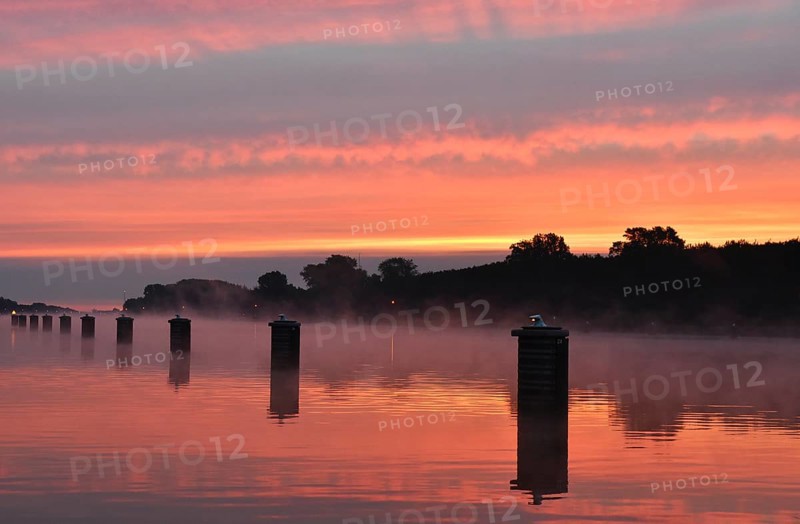Jetty, dolphins, ship's switch at sunrise and fog on the Kiel Canal, Schleswig-Holstein, Germany, Europe