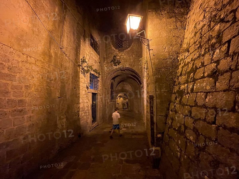 Boy in an alley in the old town of Kotor, historical, night, eerie, Bay of Kotor, Adriatic Sea, Mediterranean Sea, World Natural and Cultural Heritage, Kotor, Montenegro, Europe