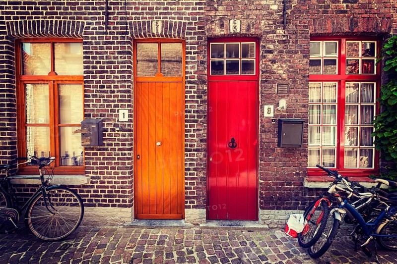 Doors of old houses and bicycles in european city. Bruges Brugge, Belgium, Europe
