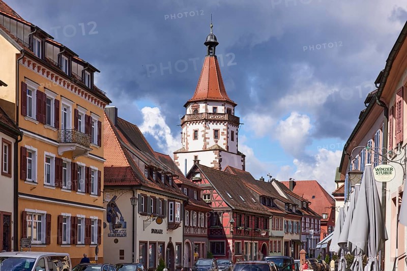 Historic tower Niggelturm and houses on the main street in rainy weather in Gengenbach, Black Forest, Ortenaukreis, Baden-Württemberg, Germany, Europe
