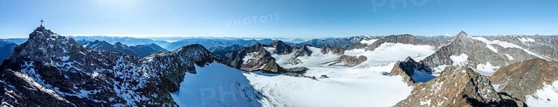 Panorama at the summit of the Wilder Freiger with summit cross and with glacier Übeltalferner and Wilder Freiger Ferner, picturesque mountain landscape, aerial view, Stubai Alps, South Tyrol, Italy, Europe