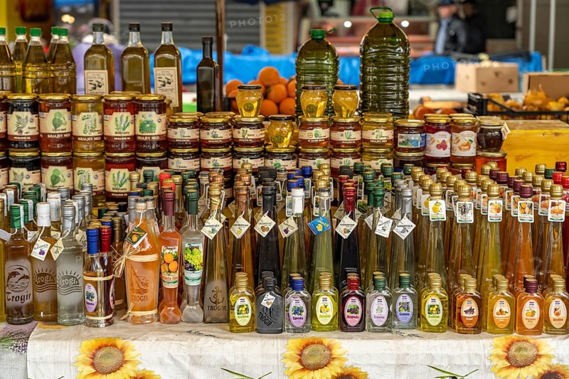 Liqueurs, schnapps, honey and olive oil at the market in Trogir, Croatia, Europe