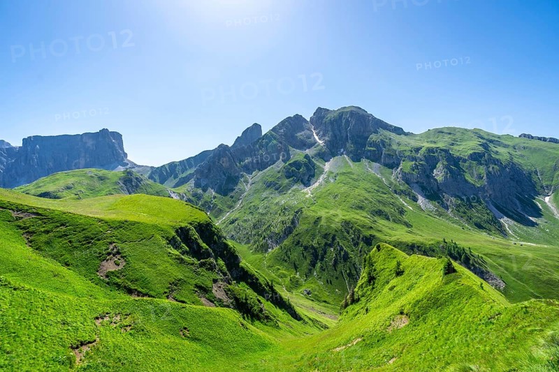 Breathtaking view of the lush green slopes and rugged peaks of passo giau in the italian dolomites during summer