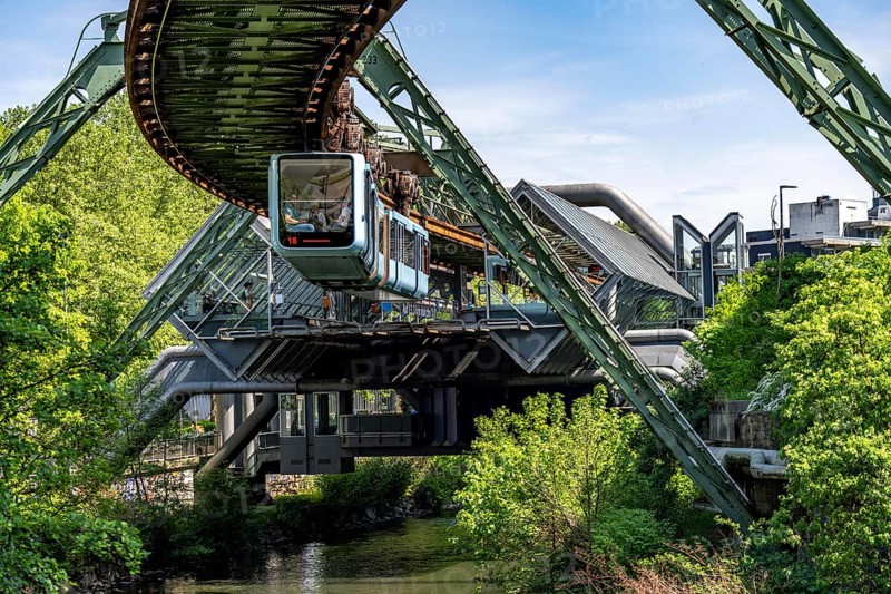 The Wuppertal suspension railway, train of the latest generation 15, floats above the Wupper, Wuppertal-Ohligsmühle station, North Rhine-Westphalia, Germany, Europe