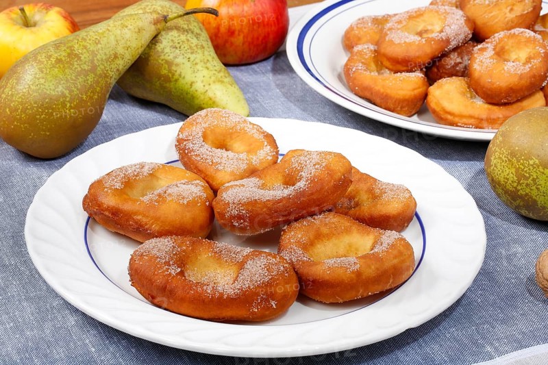 Swabian cuisine, harvest cakes, dessert, dessert, fat baked goods, doughnuts, fried food, lard noodles, arranged on a plate, grandmother's kitchen, regional, home cooking, typical Swabian, classic recipe, traditional cuisine, food photography, autumn atmosphere, apples, pears, nuts, still life, studio, Germany, Europe