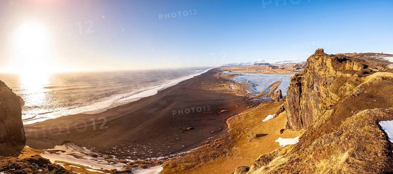 Panoramic view of Dyrholaey beach in cold winter with snow in Iceland, near Vik