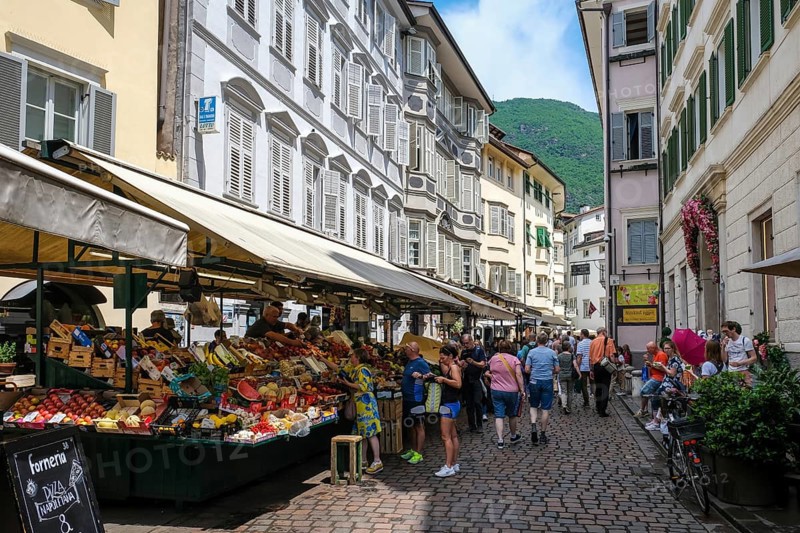 Bolzano, South Tyrol, Italy, Passers-by stroll through the fruit market on Obstplatz square in the historic city centre, Europe