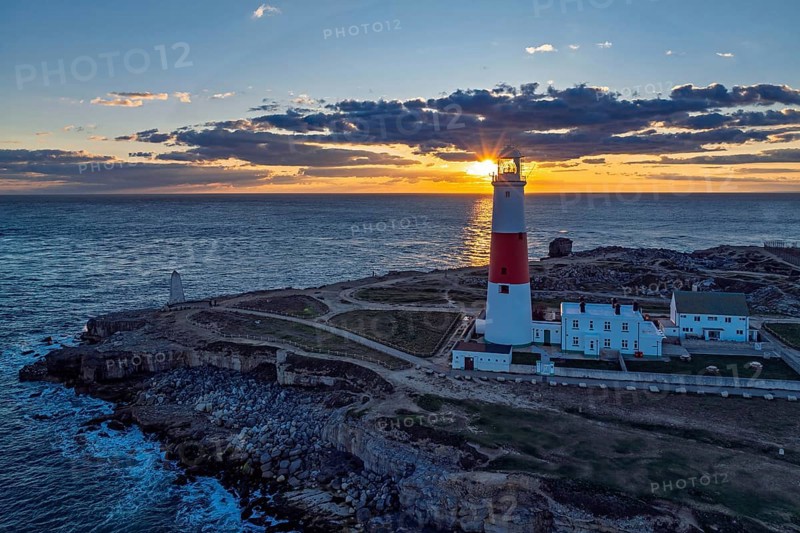 Sunset over Portland Bill Lighthouse from a drone, Portland Bill, Isle of Portland, Dorset, England, United Kingdom, Europe