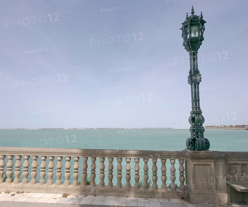 View over the bay of Cadiz with lamppost from the garden Jardines Clara Campoamor, Cádiz, Spain, Europe