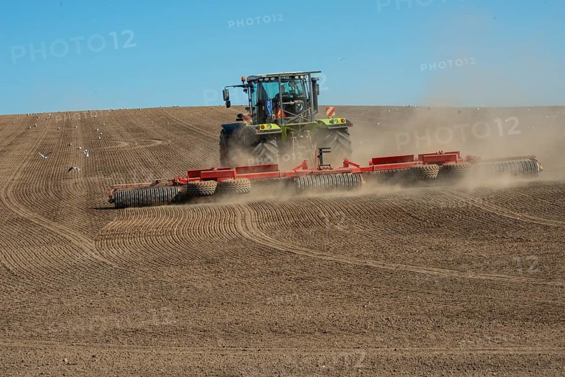 Tractor with rollers preparing the ground for spring sowing at Krageholm, Ystad Municipality, Skåne County, Sweden, Scandinavia, Europe