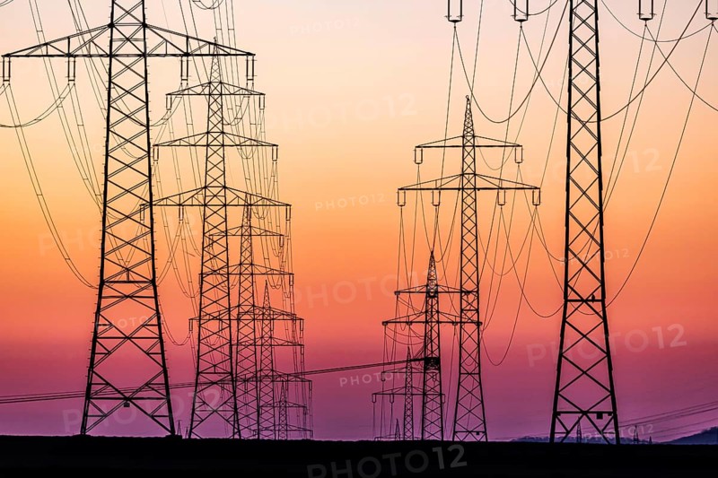 High-voltage pylons, overhead power lines at sunset. Schwieberdingen, Baden-Württemberg, Germany, Europe