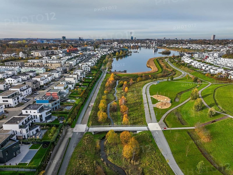 Dortmund, North Rhine-Westphalia, Germany, Phoenix Lake, front of the renaturalised Emscher. The river has been transformed into a near-natural body of water, flood protection and biodiversity through newly designed floodplains. A former industrial wasteland of 99 hectares was transformed into residential, work and leisure areas and 24 hectares of lake surface. In the event of heavy rainfall, the lake acts as a rainwater retention basin. Following the construction of a parallel sewer, the Emscher is now free of wastewater, having previously been an open, above-ground wastewater sewer, combined sewer with surface water and wastewater. The Phoenix Lake, a showcase project for structural change, is an artificial lake on the site of the former Phönix Ost steelworks in Dortmund's Hörde district, Europe
