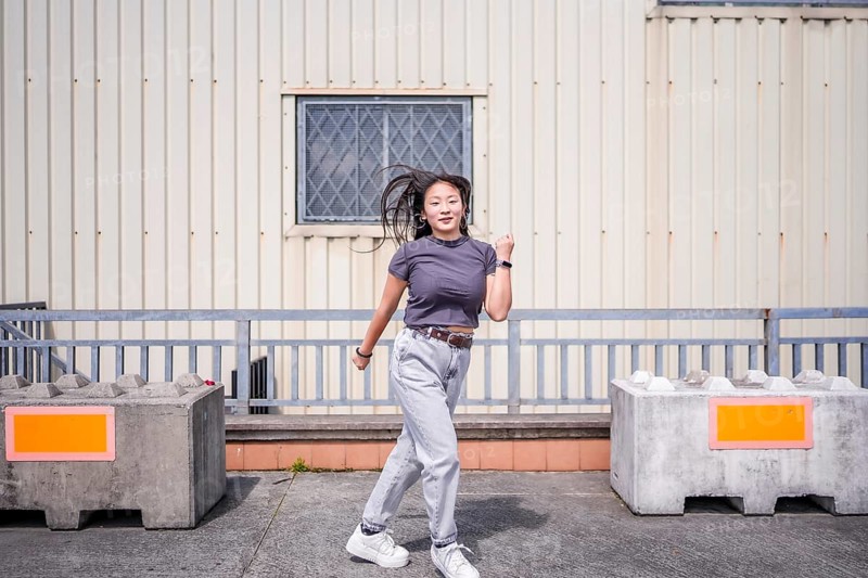 Modern young beauty woman dancing k-pop korean dance in the city