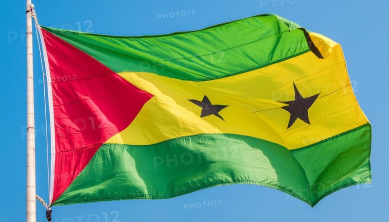 The flag of the Democratic Republic of Sao Tome, Africa, flutters in the wind, isolated against a blue sky