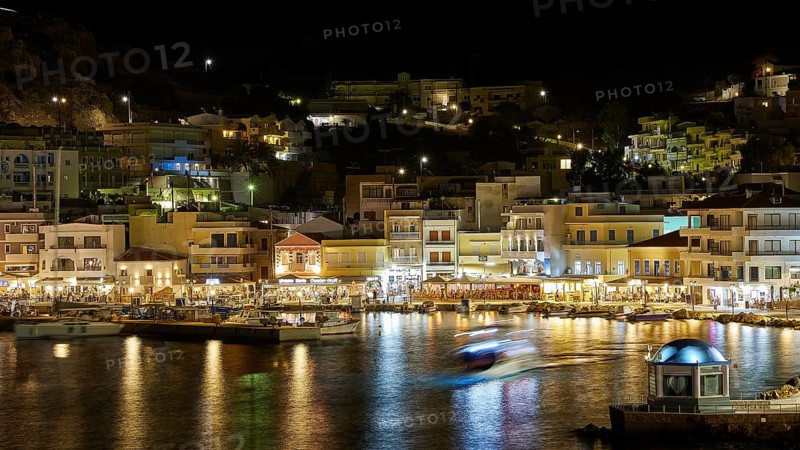 Night shot of a harbour with illuminated buildings and reflecting lights in the water, Pigadia, town and harbour, Pigadia Bay, main town, Karpathos, Dodecanese, Greek Islands, Greece, Europe