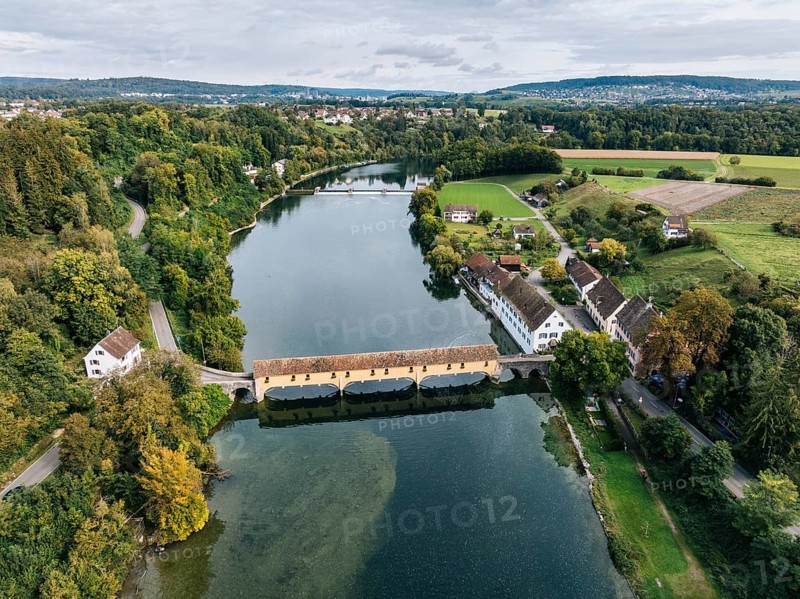 Aerial view of the covered Rhine bridge connecting the Swiss municipality of Rheinau and the German municipality of Altenburg. The bridge is one of the now rare Pfahljoch bridges in the canton of Zurich, Switzerland, Europe