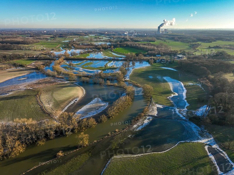 Selm, North Rhine-Westphalia, Germany, flood on the Lippe, river in the Ruhr area, the fields, the farmers' agricultural land next to the watercourse are flooded, serve as retention areas, flood areas for flood protection. In the background the Trianel coal-fired power station in Lünen, Europe