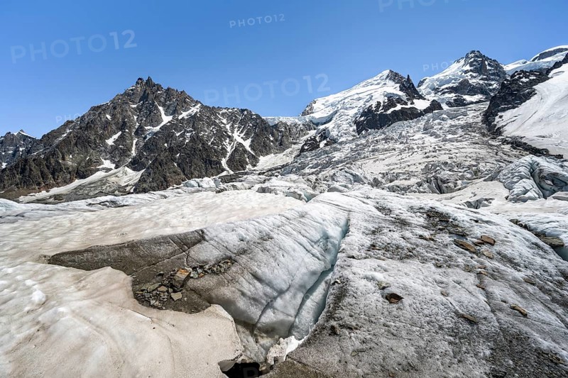 High alpine glaciated mountain landscape, La Jonction, Glacier des Bossons meets Glacier de Taconnaz, summit of Aiguille du Midi, Mont Maudit and Mont Blanc, Chamonix, Haute-Savoie, France, Europe
