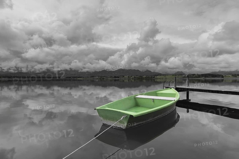 Storm clouds at sunset, a green rowing boat lashed to the wooden jetty, Hopfensee, Hopfen am See, near Füssen, Ostallgäu, Allgäu, Bavaria, Germany, Europe