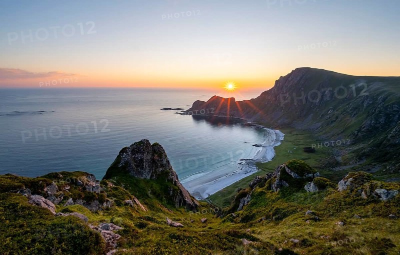 View of coastal landscape at sunset, cliffs and summit of Måtind or Måtinden, Høyvika beach and sea, Andøya island, Vesterålen, Nordland Norway