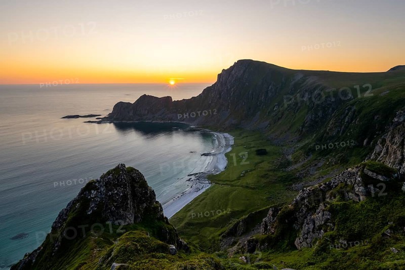 View of coastal landscape at sunset, cliffs and summit of Måtind or Måtinden, Høyvika beach and sea, Andøya island, Vesterålen, Nordland Norway