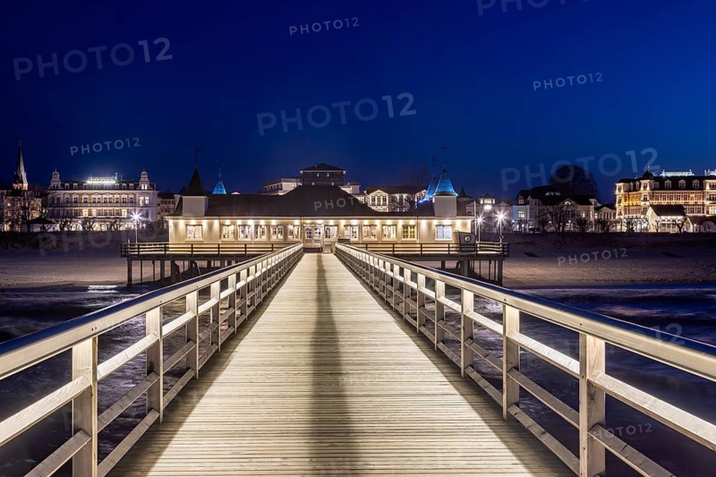 Restaurant on Ahlbeck Pier, Seebrücke Ahlbeck illuminated at dusk in the Baltic Sea on Usedom island, Mecklenburg-Vorpommern, oldest pier in Germany