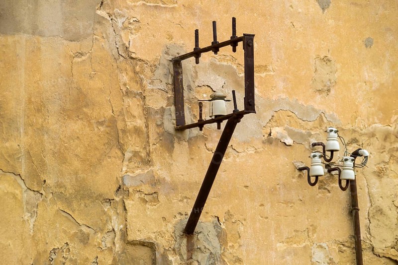 Power lines on a house wall with ceramic insulators, Agrigento, Agrigento, Sicily, Italy, Europe