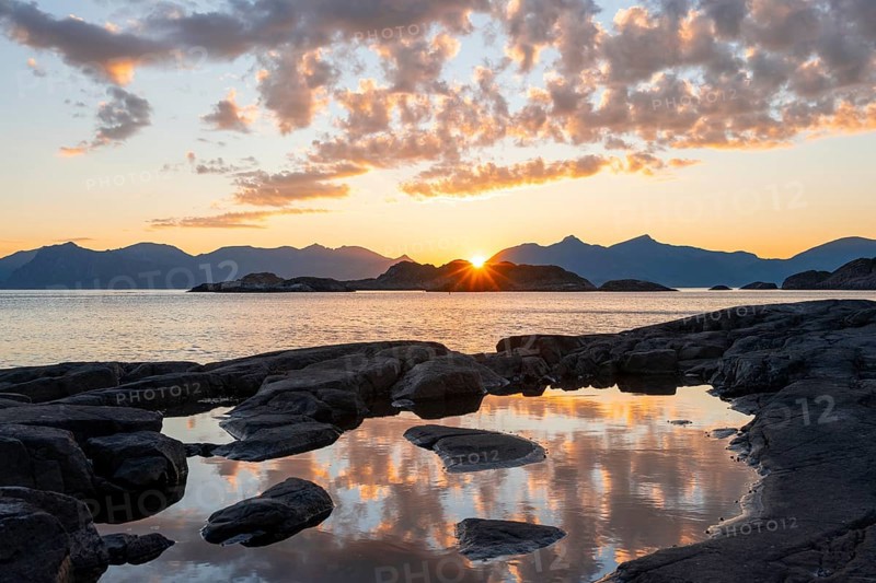 Clouds reflected in a small pond on a rocky coast, coastal landscape at sunset, Henningsvær, Lofoten, Nordland, Norway, Europe