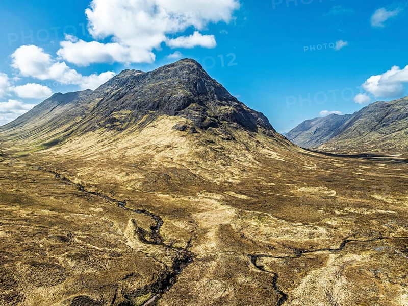 Buachaille Etive Beag and Three Sisters in Glencoe over Moors and Road A82 from a drone, Highlands, Scotland, United Kingdom, Europe