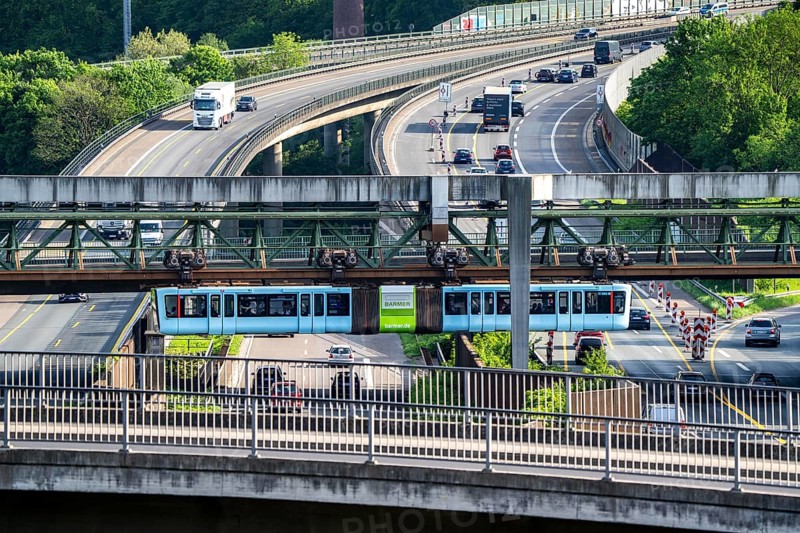 The Wuppertal suspension railway, train of the latest generation 15, crosses the A46 motorway, Sonnborner Kreuz, North Rhine-Westphalia, Germany, Europe