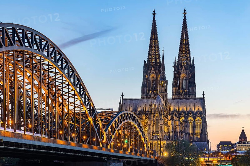 Cologne Cathedral, illuminated in the evening. Hohenzollern Bridge, railway bridge over the Rhine. City view of Cologne, North Rhine-Westphalia, Germany, Europe