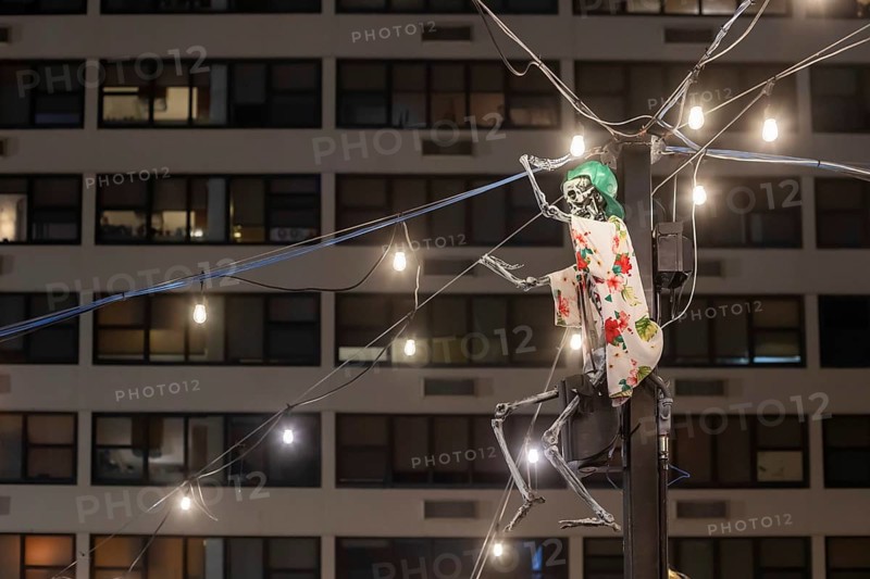 New Orleans, Louisiana - A skeleton wearing a dress watches over a street market in the Marigny neighborhood