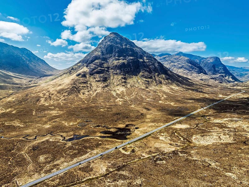 Buachaille Etive Beag and Three Sisters in Glencoe over Moors and Road A82 from a drone, Highlands, Scotland, United Kingdom, Europe