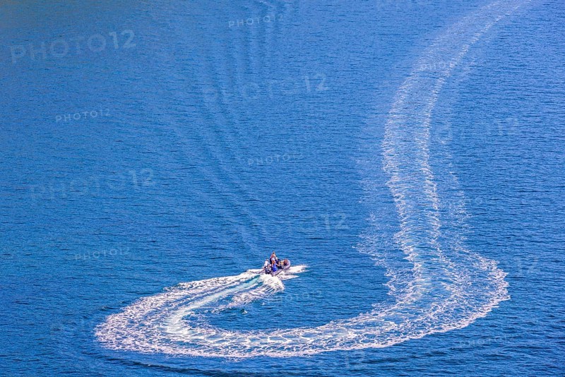 Motorboat that has made a turn on the sea with white wake pattern, Crozon peninsula, Bretagne, France, Europe