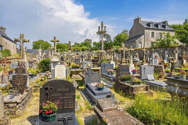 Tombstones in an old cemetery in a French old village, Locronan, Bretagne, France, Europe