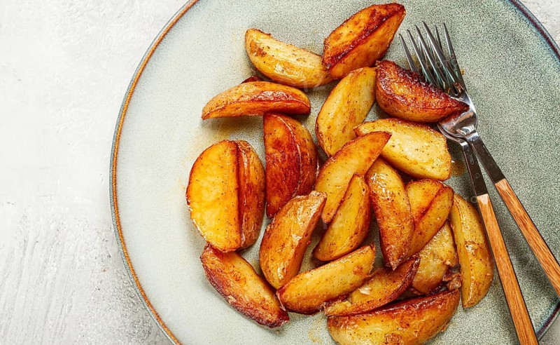 Fried potato slices, on a plate, top view, homemade, no people