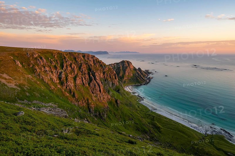View of coastal landscape at sunset, cliffs, Høyvika beach and sea, hike to the summit of Måtind or Måtinden, Andøya island, Vesterålen, Nordland Norway