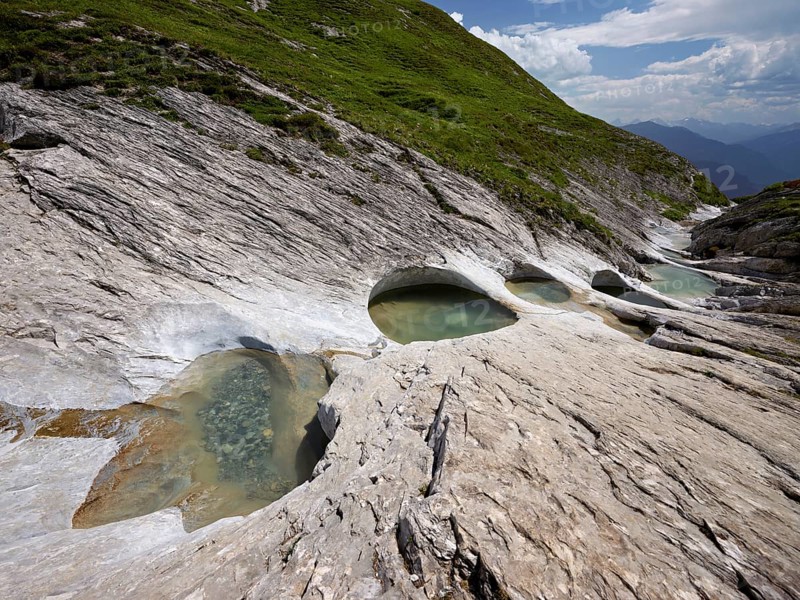 Glacier mill with glacier pots on the Trinser Alp Mora, Trin, Canton Graubünden, Switzerland, Europe