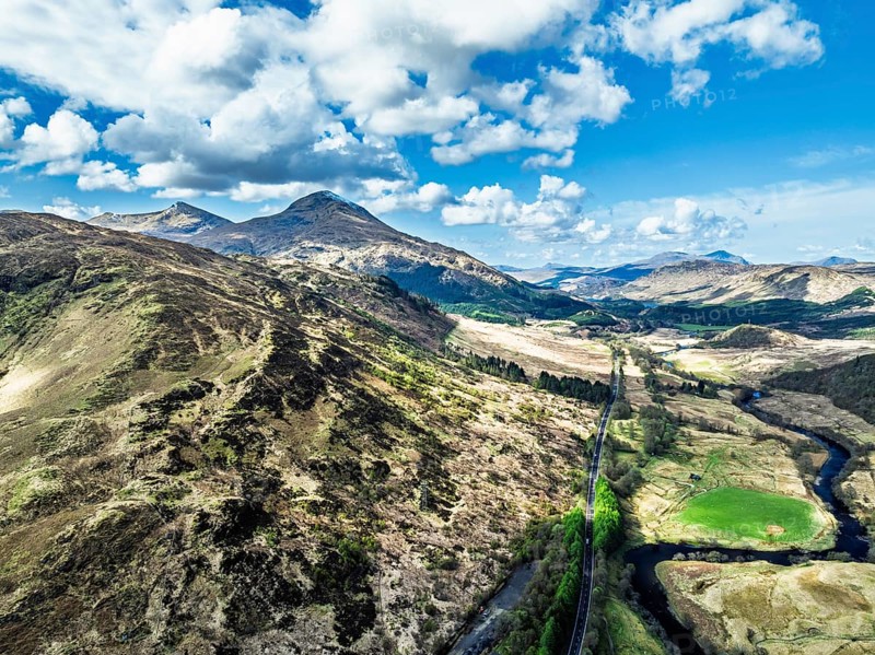 Farms and Mountains over River Dochart and Road A85 from a drone, Perthshire, Scotland, UK
