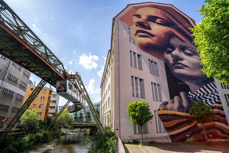 Street art in Wuppertal, large murals by international artists can be seen on over 40 house walls, here the mural IDENTITY, Hofaue 49, Edition 2023, by the Argentinian street art duo Medianeras, in Elberfeld Mitte, North Rhine-Westphalia, Germany, Europe