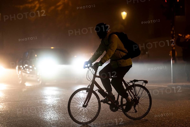 Cyclist, darkness, inner city traffic, fog, autumn, winter, evening traffic, North Rhine-Westphalia, Germany, Europe