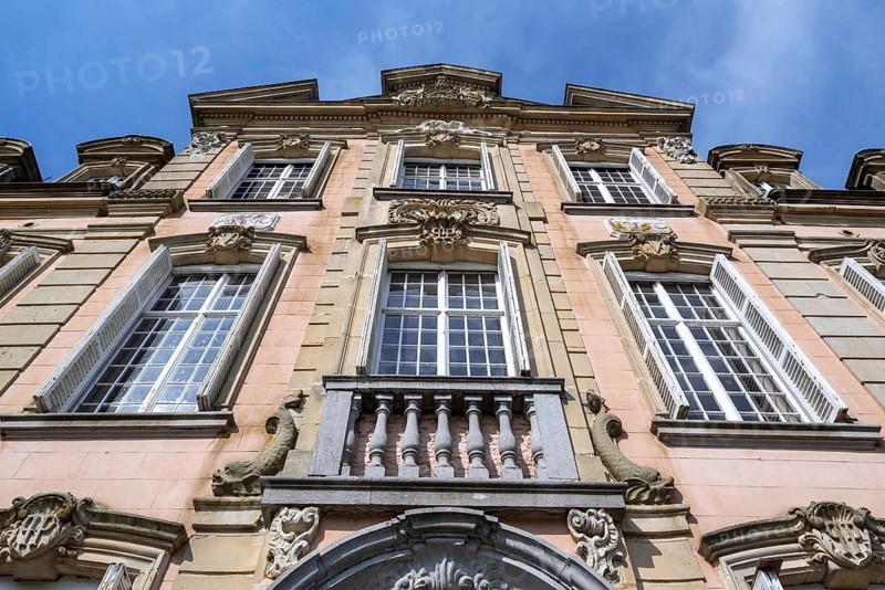Façade with high relief architectural ornaments above windows of 1750 Poeke Castle, Kasteel van Poeke in Rococo style, Aalter, East Flanders, Belgium, Europe