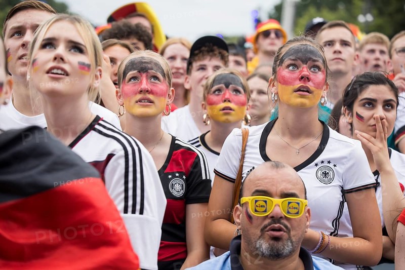 Women wearing make-up in the German national colours watch the football match in the fan zone at the Brandenburg Tor during the quarter-final match between Germany and Spain at the European Football Championship, Berlin, 05.07.2024