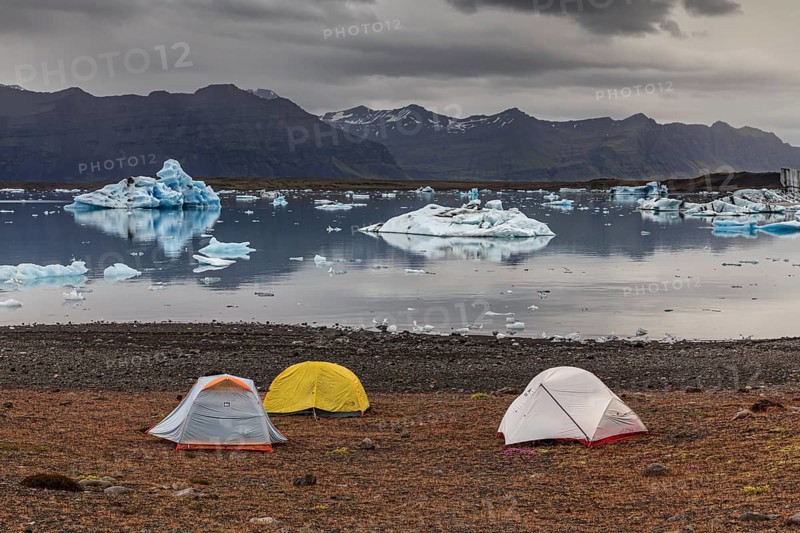 Tents in front of glacier lagoon, icebergs, camping, mountains, cloudy, winter, Jökulsarlon, Iceland, Europe