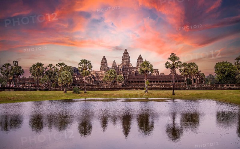 Angkor Wat main temple reflected in the water in a beautiful summer sunrise. Cambodia