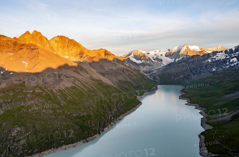 Picturesque mountain landscape at the summit Mont de la Blana at sunset, view of blue mountain lake, reservoir Lac des Dix and summit Mont Blanc de Cheilon with glacier, Hérémence, Valais, Western Alps, Switzerland, Europe