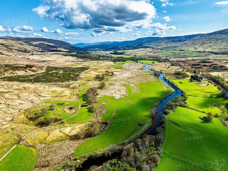 Farms and Mountains over River Dochart and Road A85 from a drone, Perthshire, Scotland, UK